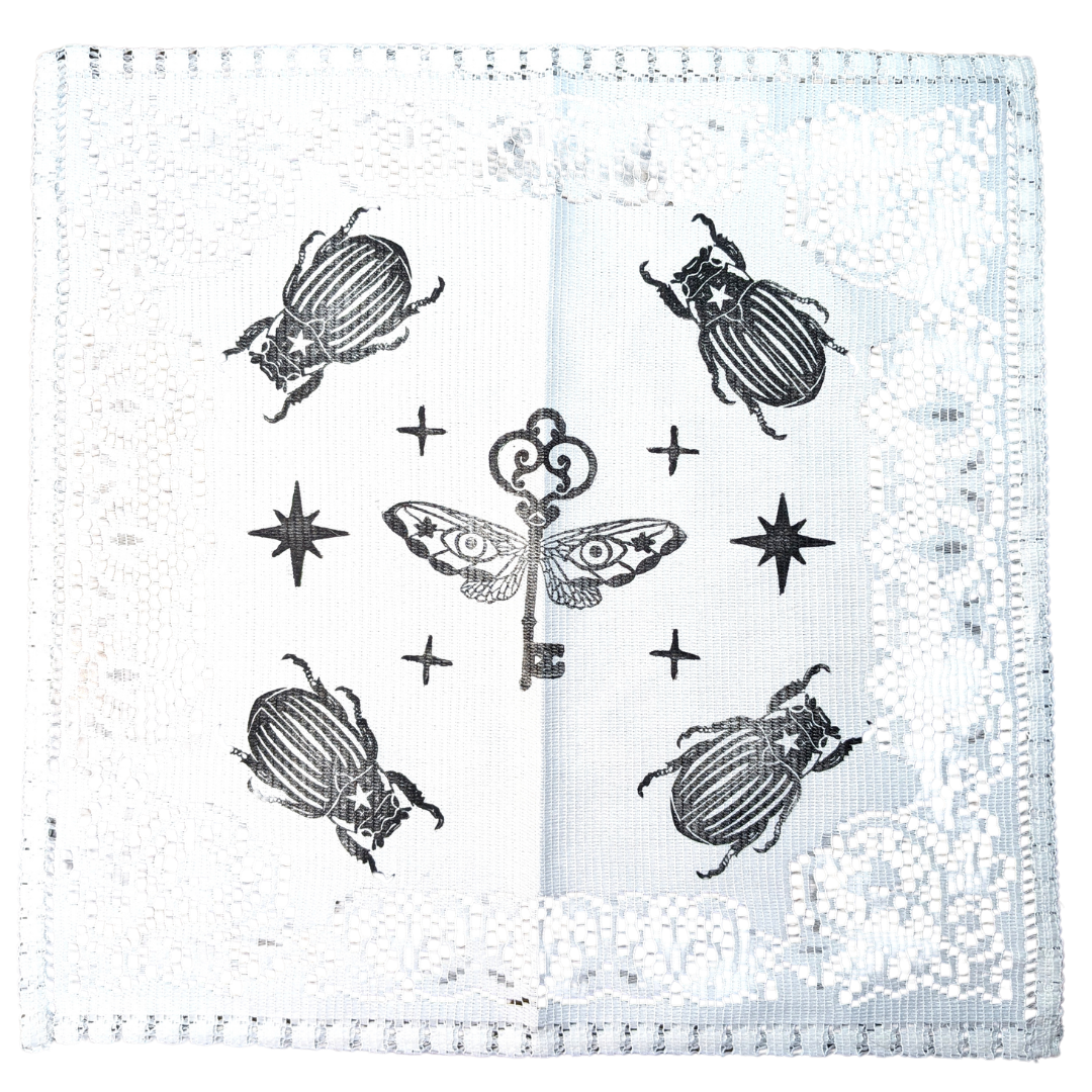 White doily with black Key & Bugs