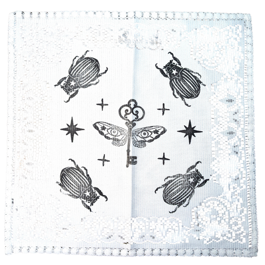 White doily with black Key & Bugs